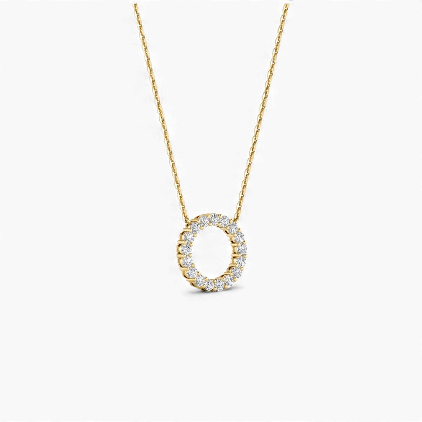 Gold necklace with a circular pendant on a white background