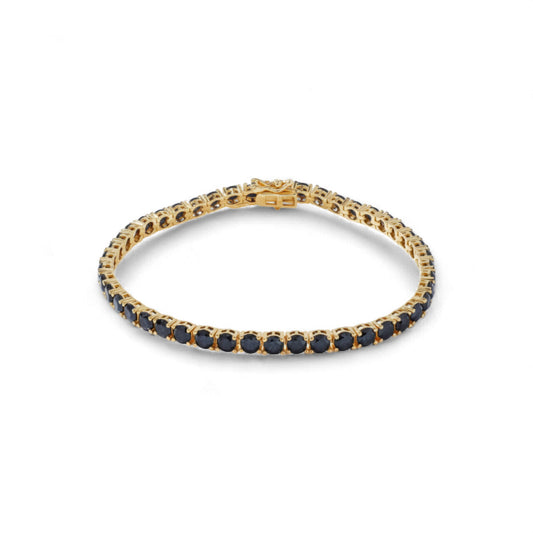 Gold bracelet with black stones on a white background