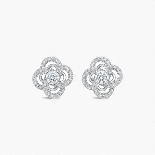 Pair of silver flower-shaped earrings on a white background