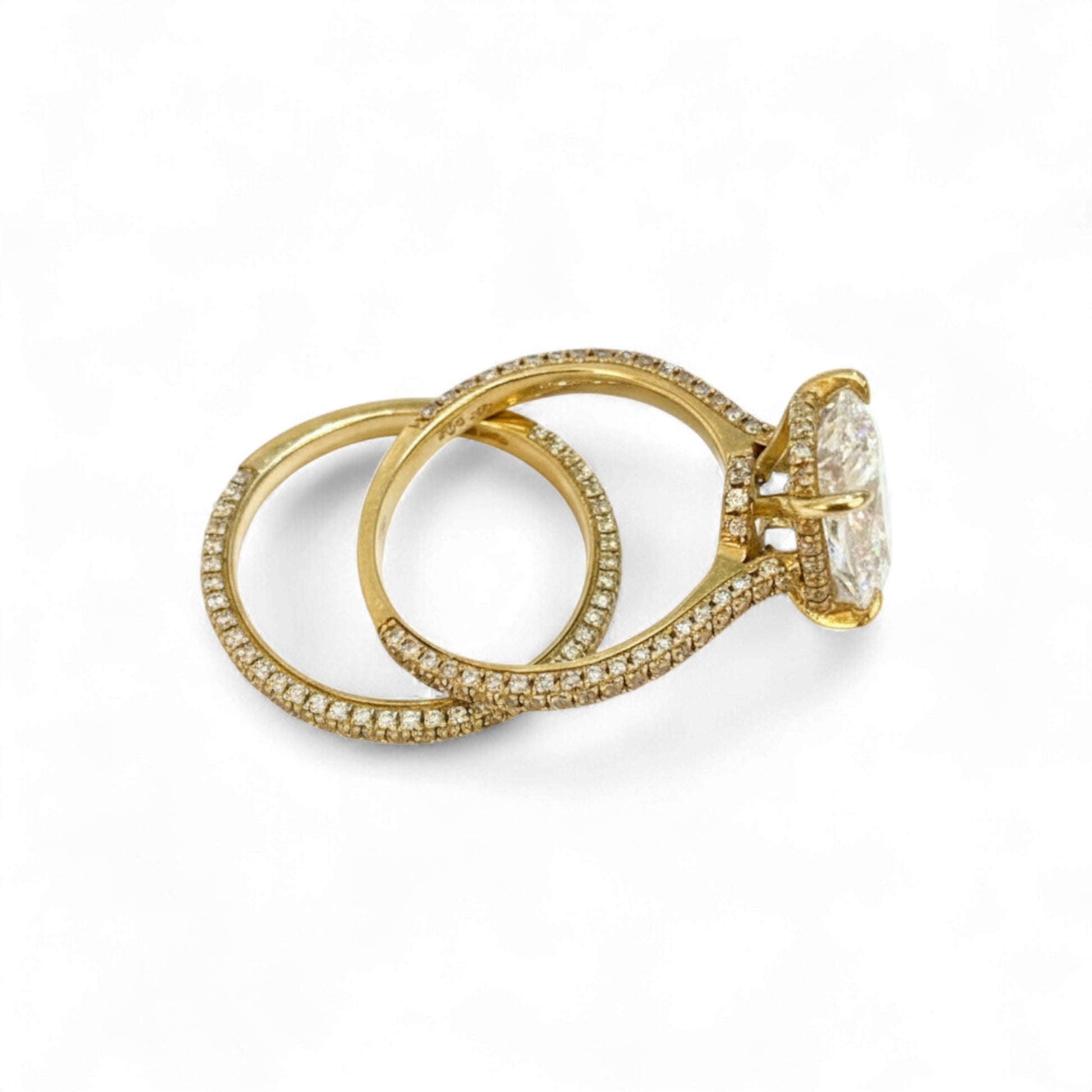 Gold ring with a large diamond and smaller diamonds on a white background