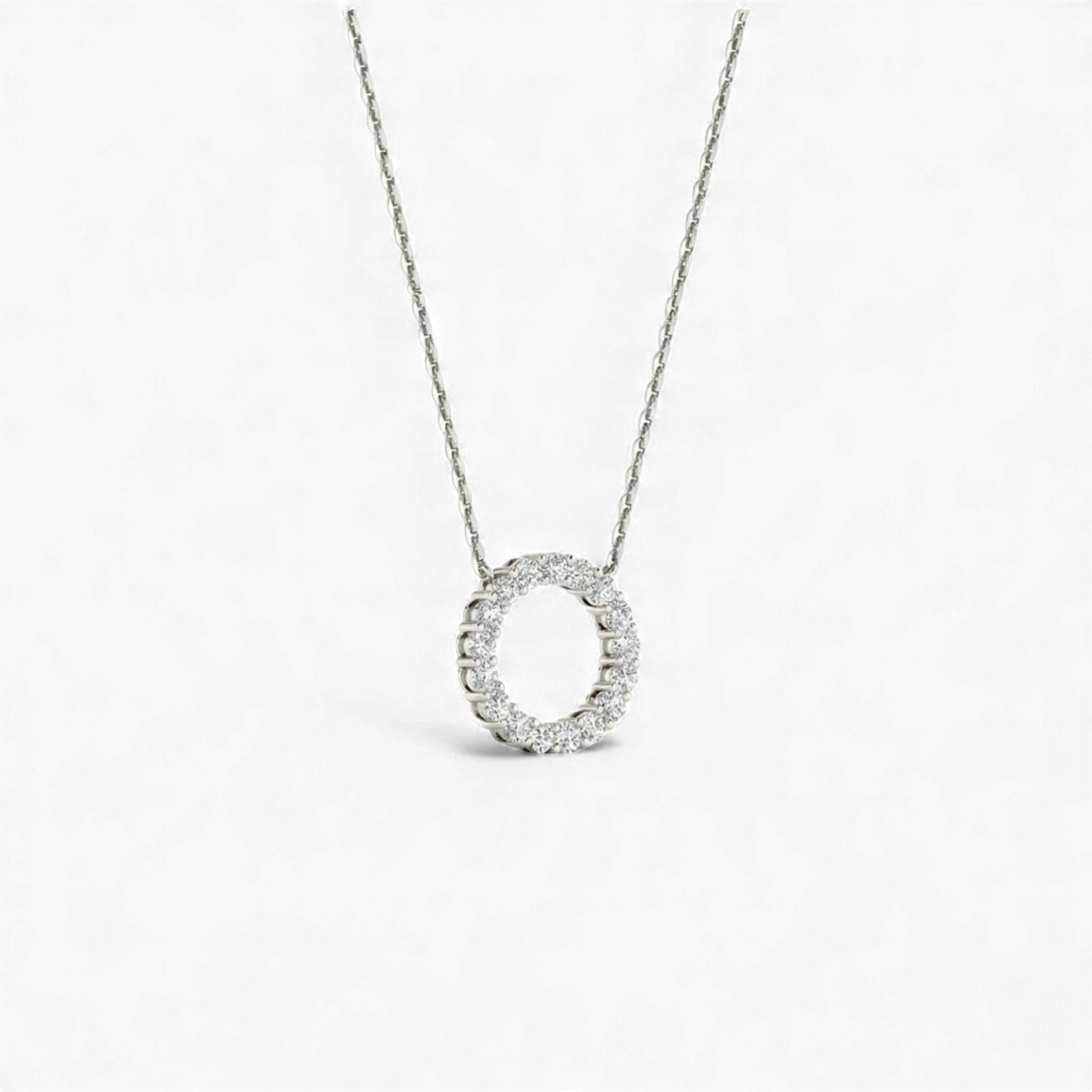 Silver necklace with a circular pendant on a white background