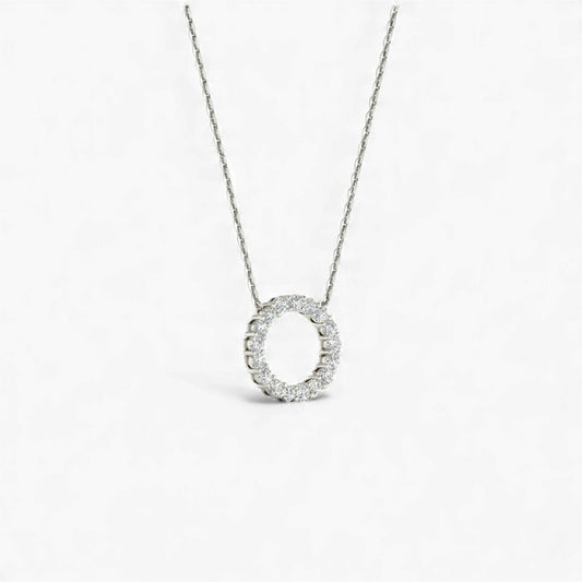 Silver necklace with a circular pendant on a white background