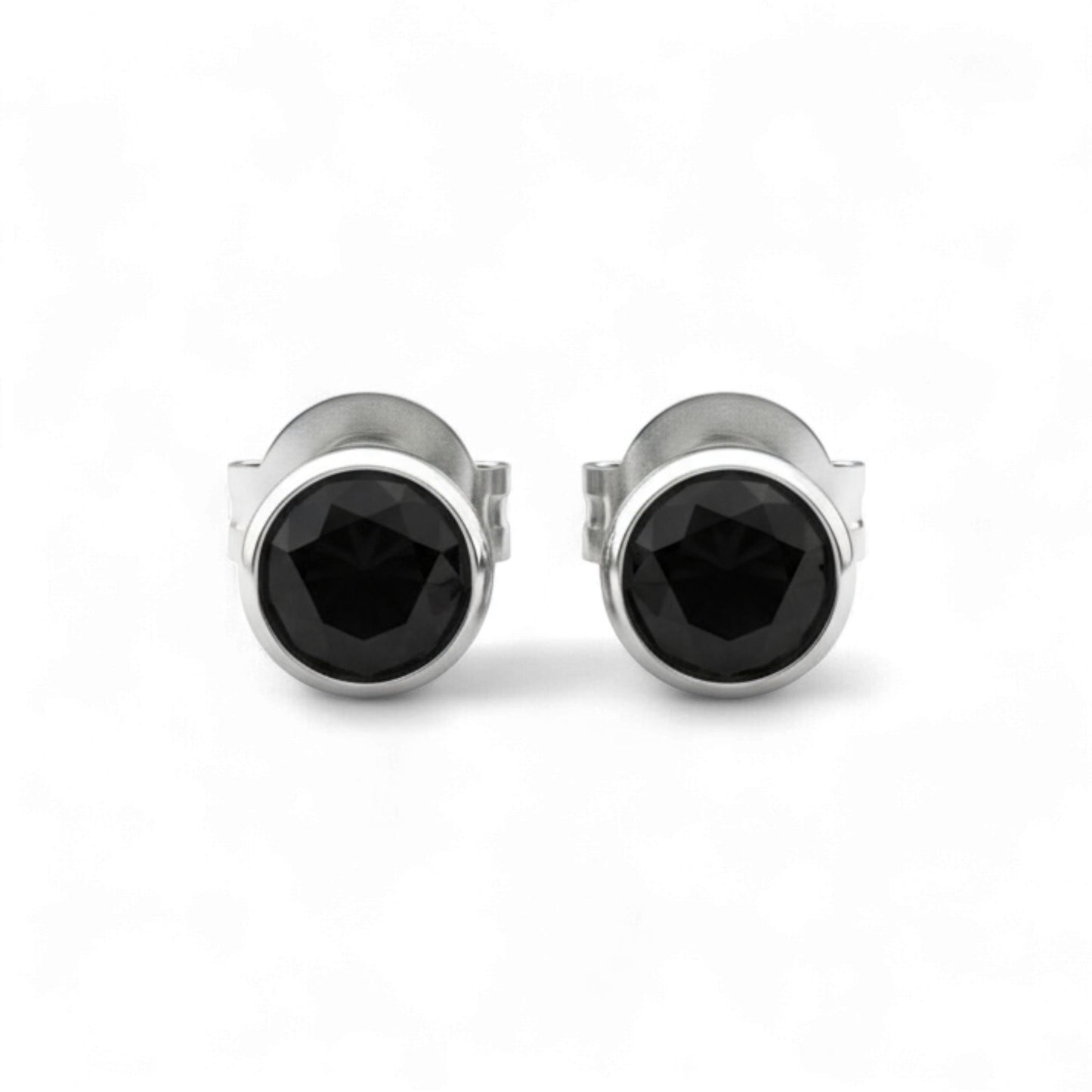 Pair of silver stud earrings with black gemstones on a white background