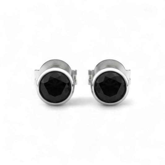 Pair of silver stud earrings with black gemstones on a white background