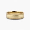 Gold ring with textured band on a white background