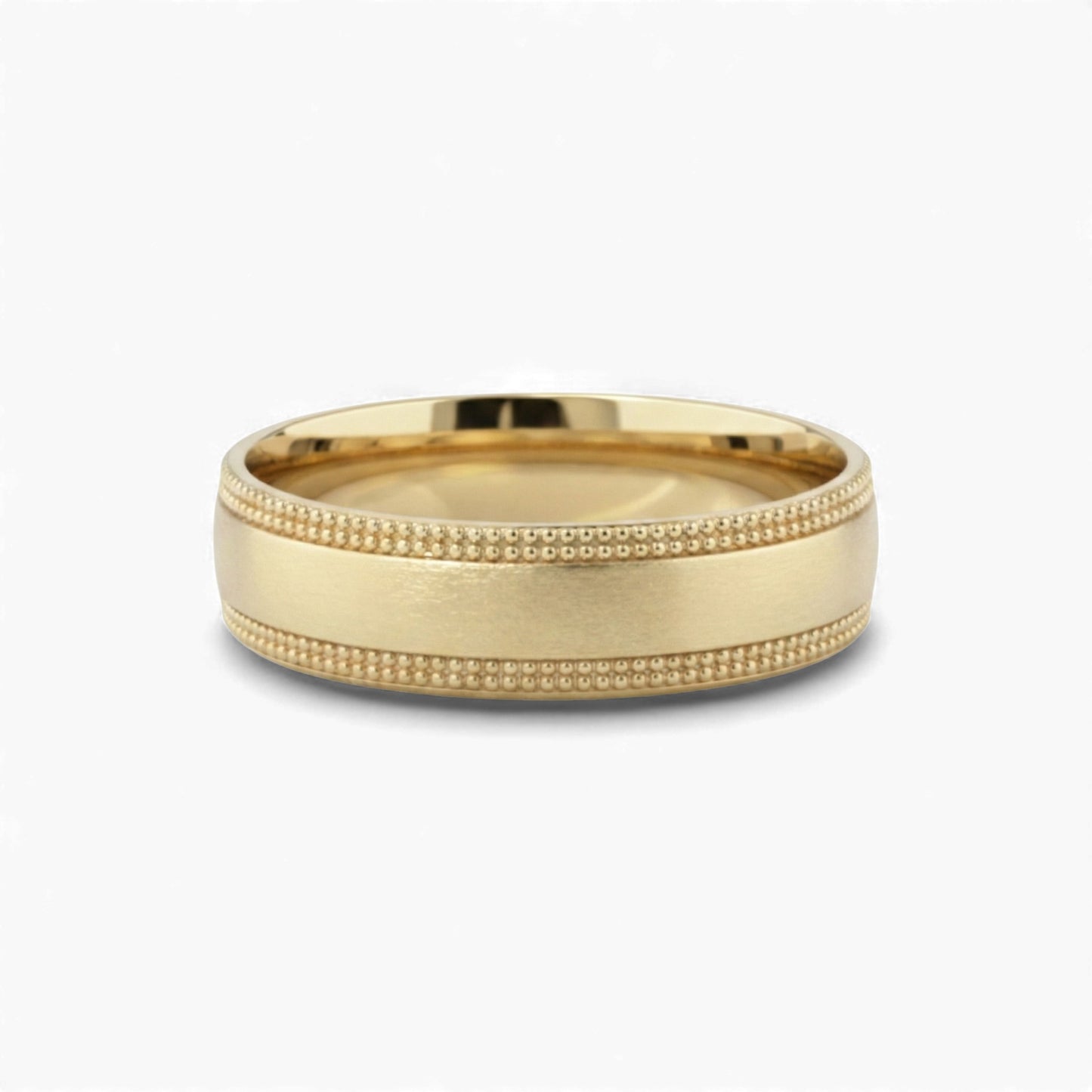 Gold ring with textured band on a white background
