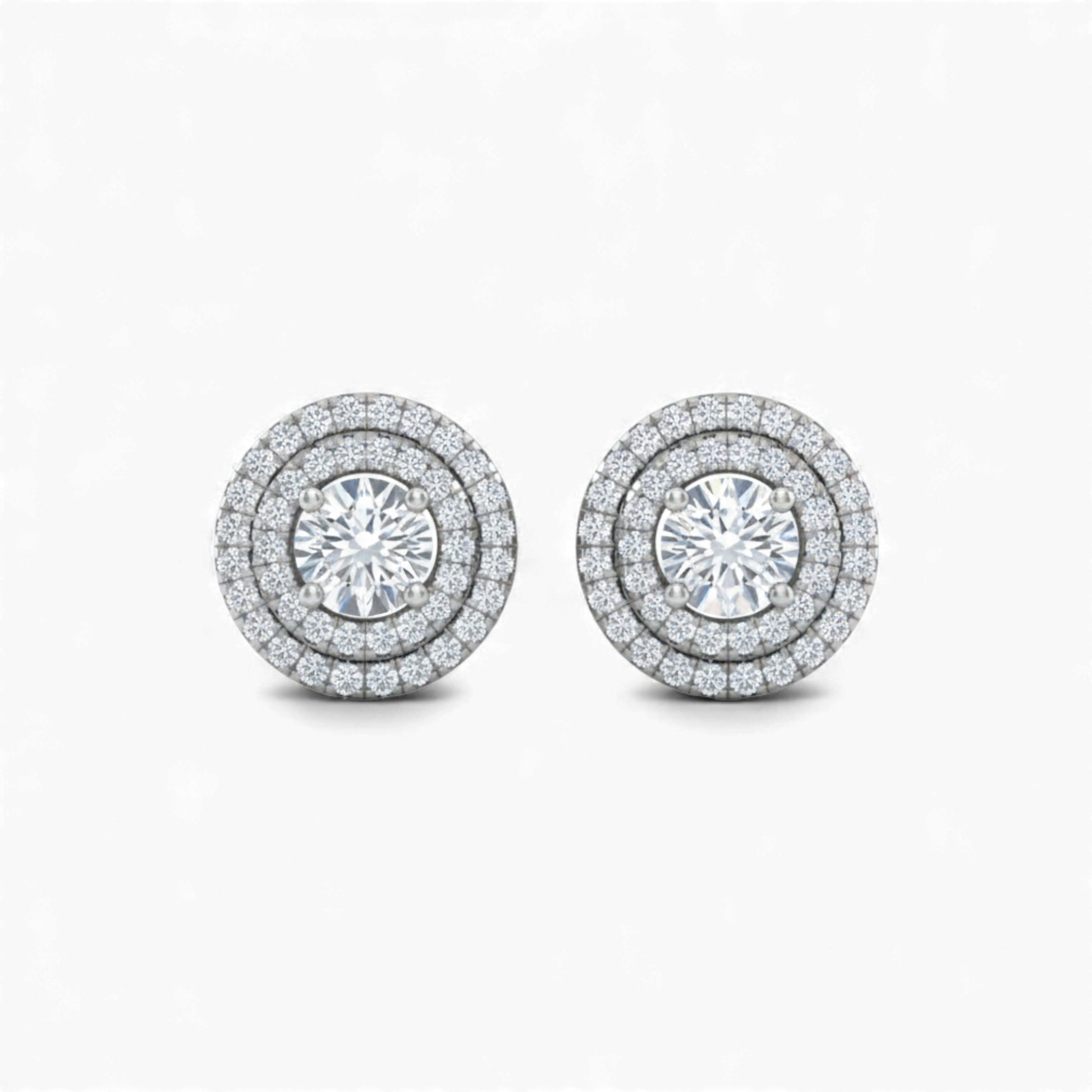 Pair of diamond stud earrings on a white background