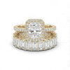 Gold ring with emerald-cut diamond and baguette diamonds on a white background