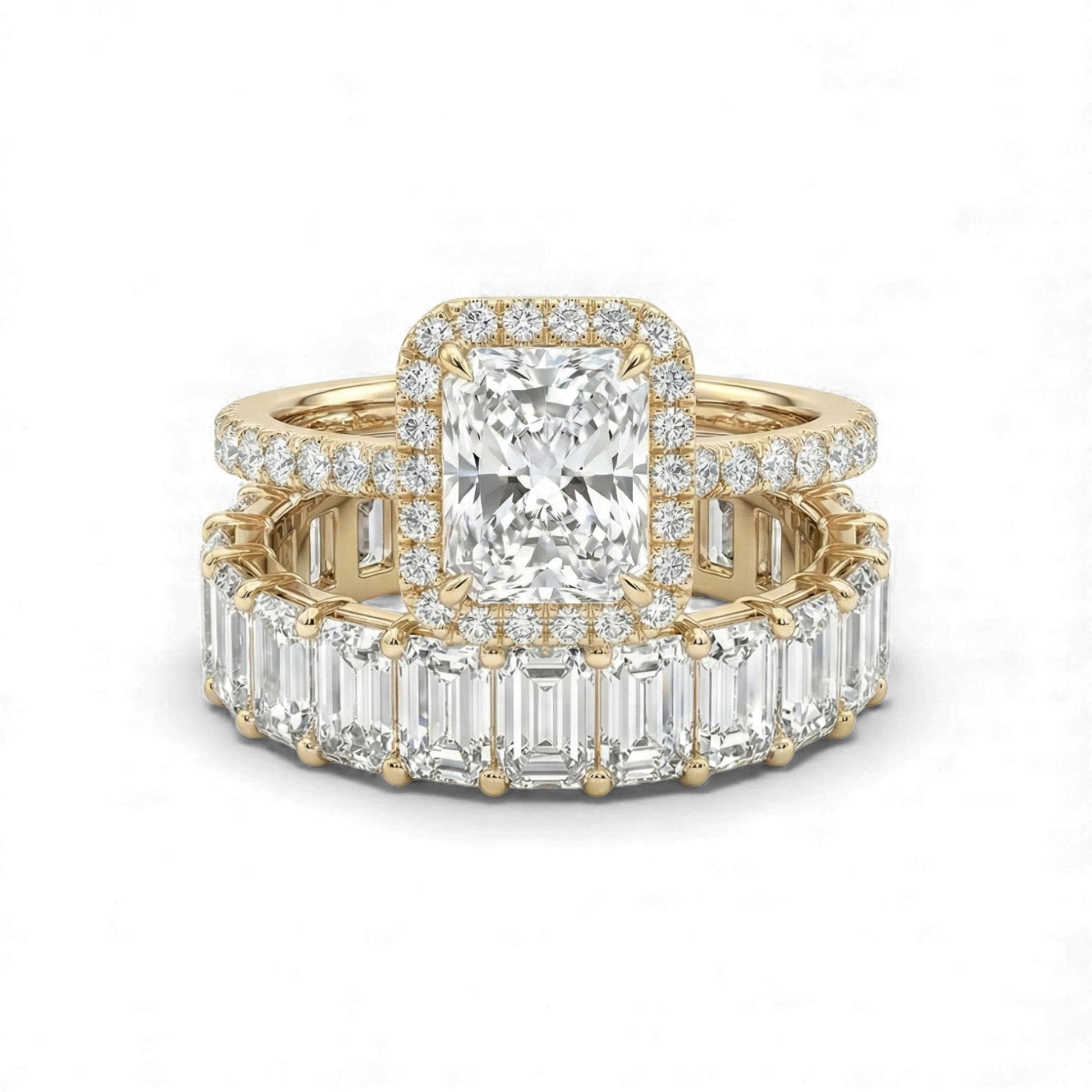 Gold ring with emerald-cut diamond and baguette diamonds on a white background