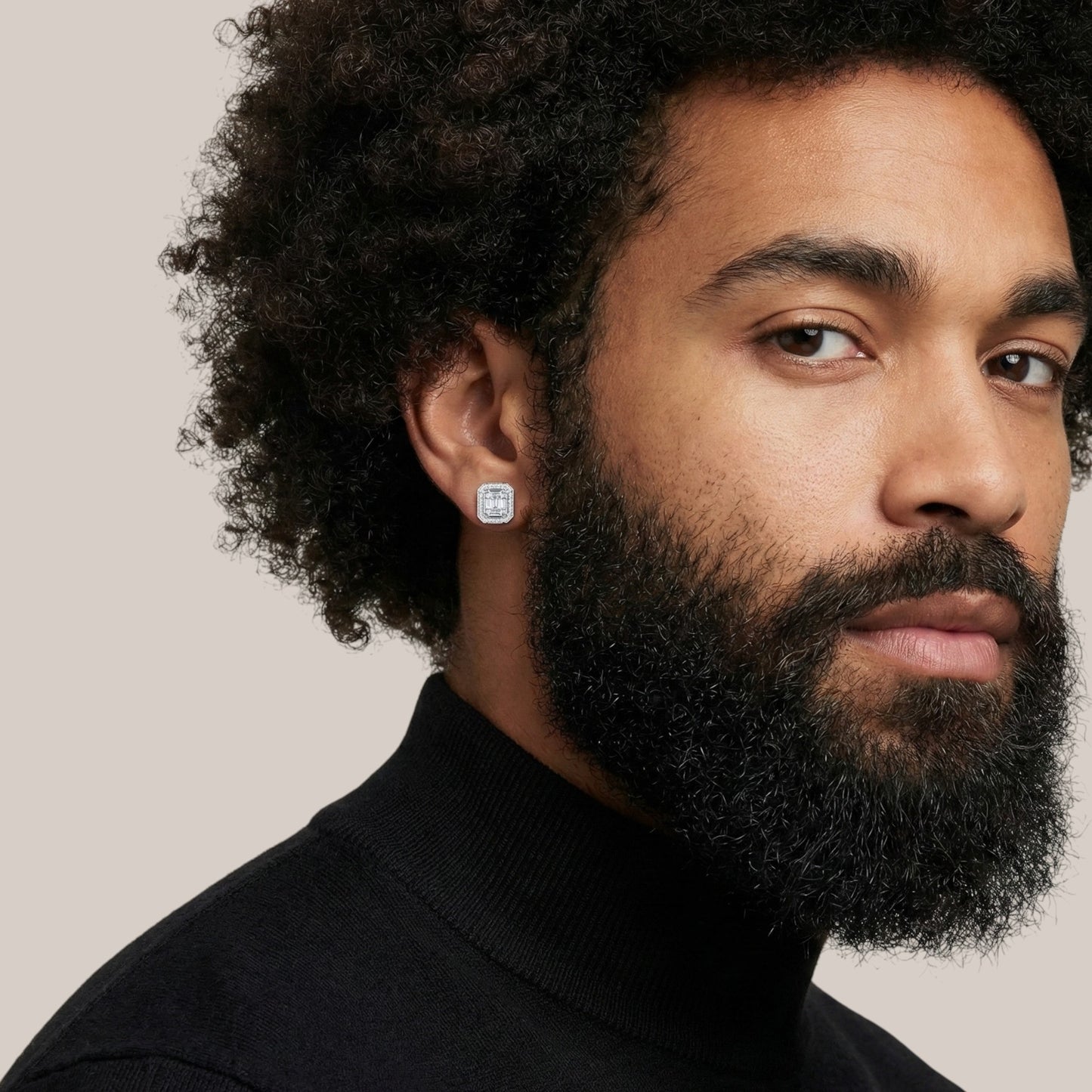 Man wearing a black turtleneck with a neutral background