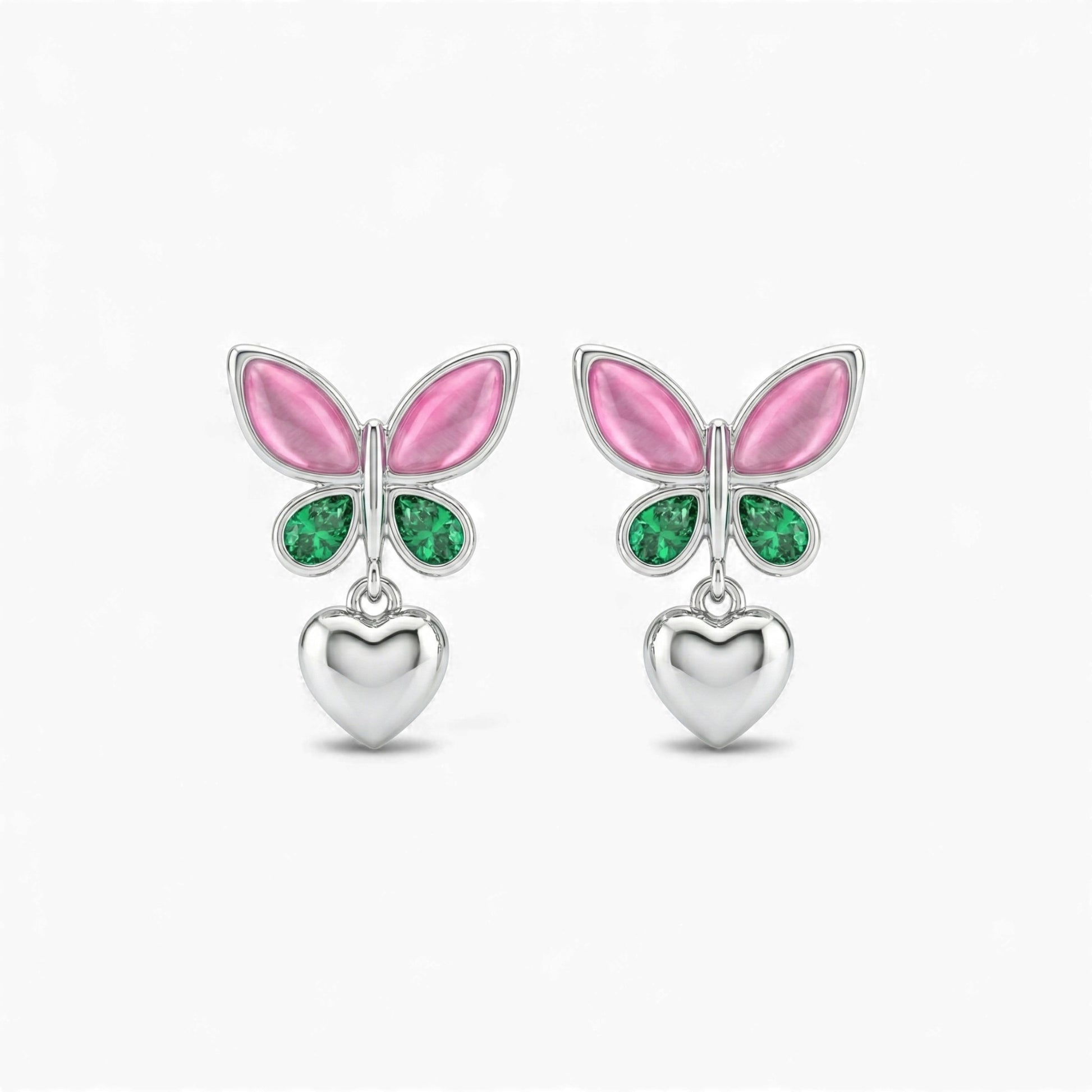 Butterfly-shaped earrings with pink wings and green gemstones on a white background