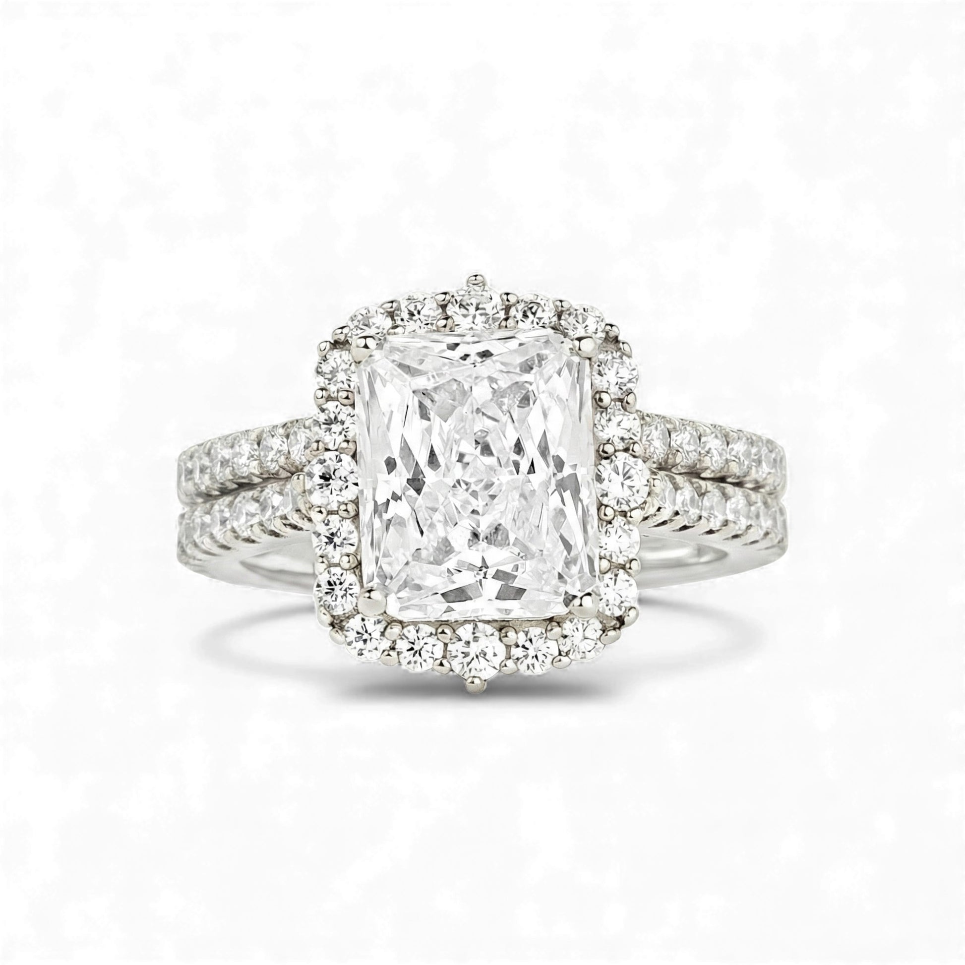 Diamond ring with a large central gemstone and smaller stones on a white background