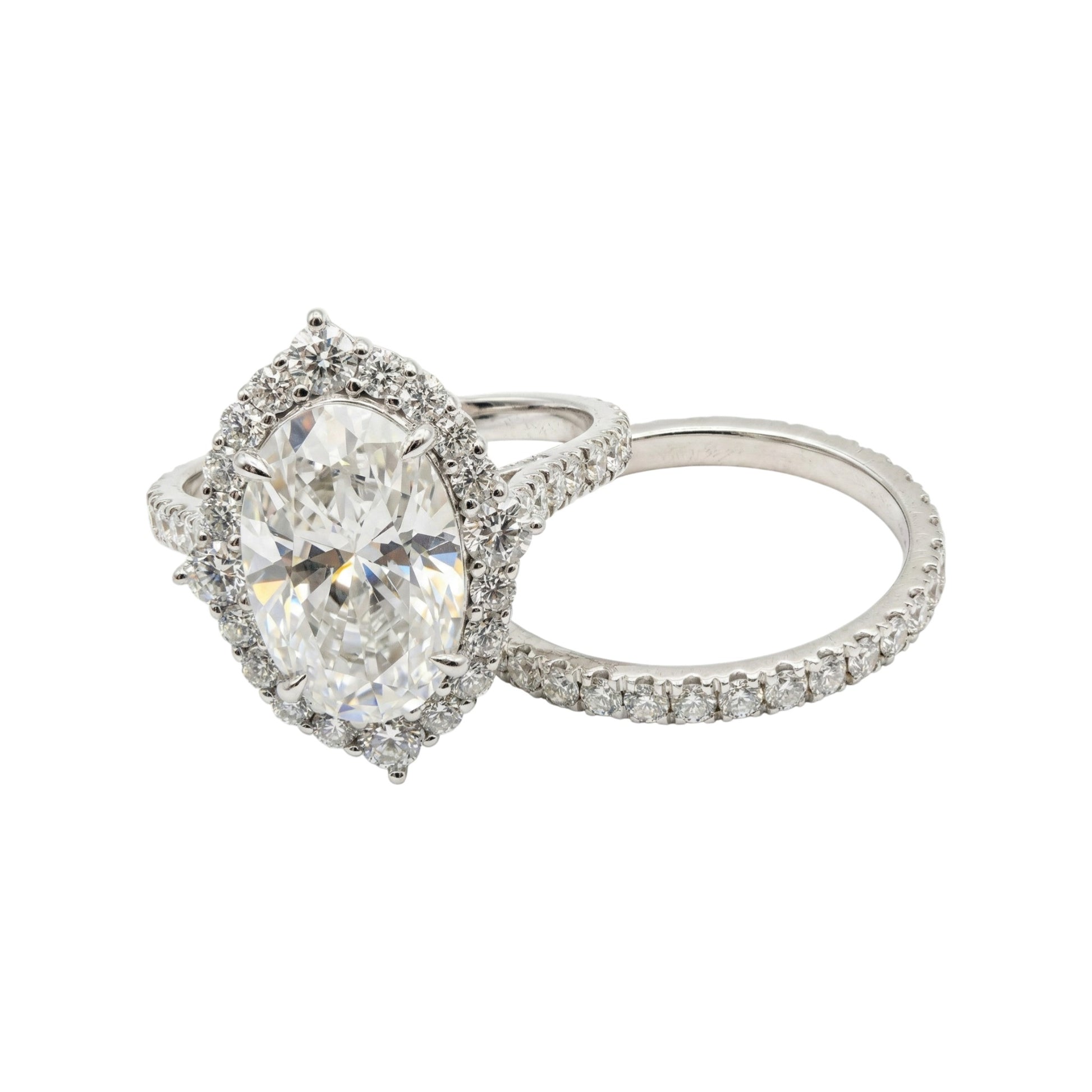Silver ring with a large central gemstone and smaller stones on a white background