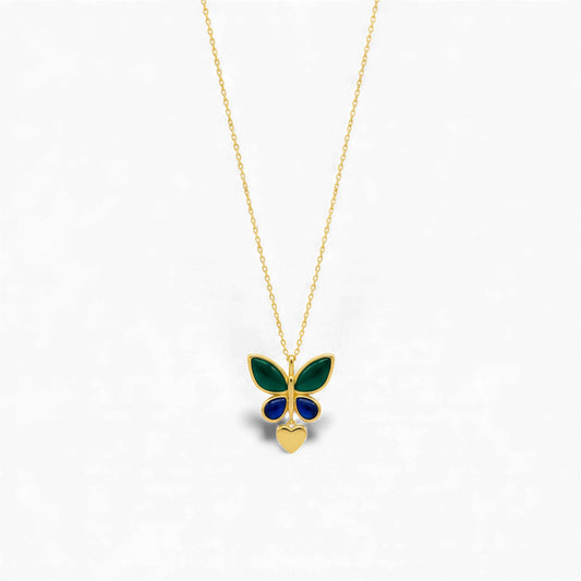 Butterfly-shaped pendant on a gold chain against a white background