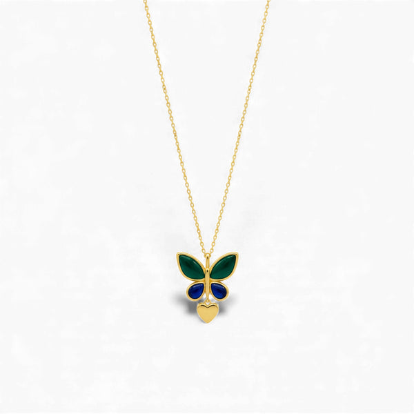 Butterfly-shaped pendant on a gold chain against a white background