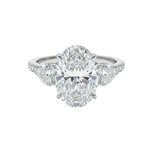 Diamond ring with a large central gemstone and smaller stones on a white background