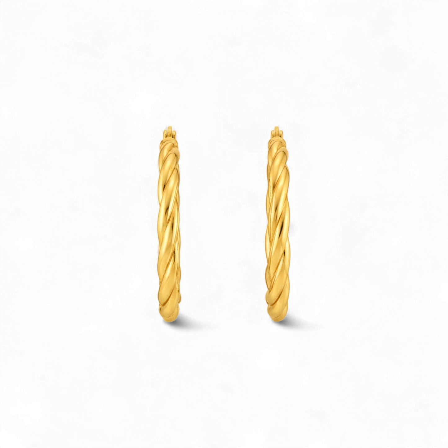 Pair of gold hoop earrings on a white background