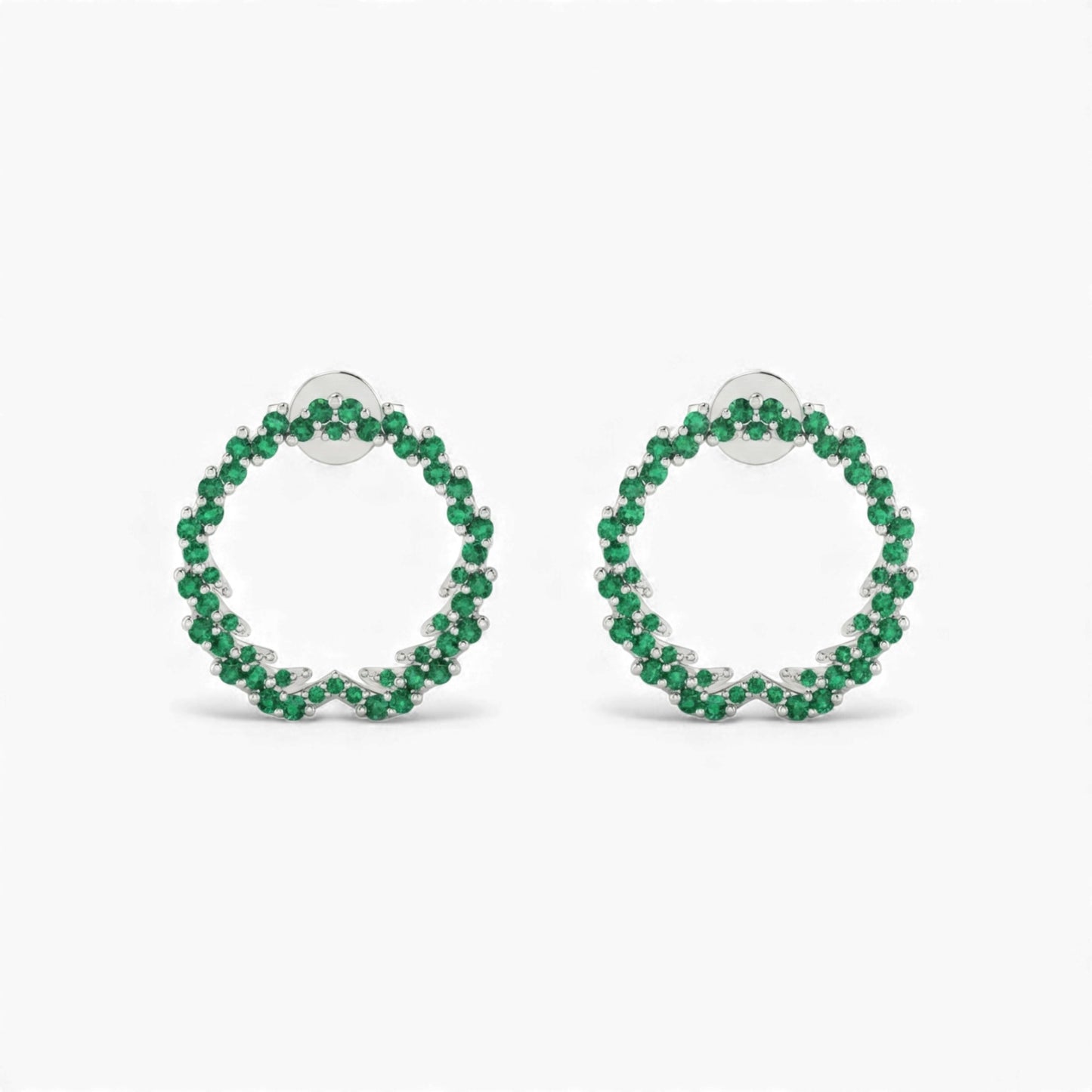 Pair of green hoop earrings on a white background
