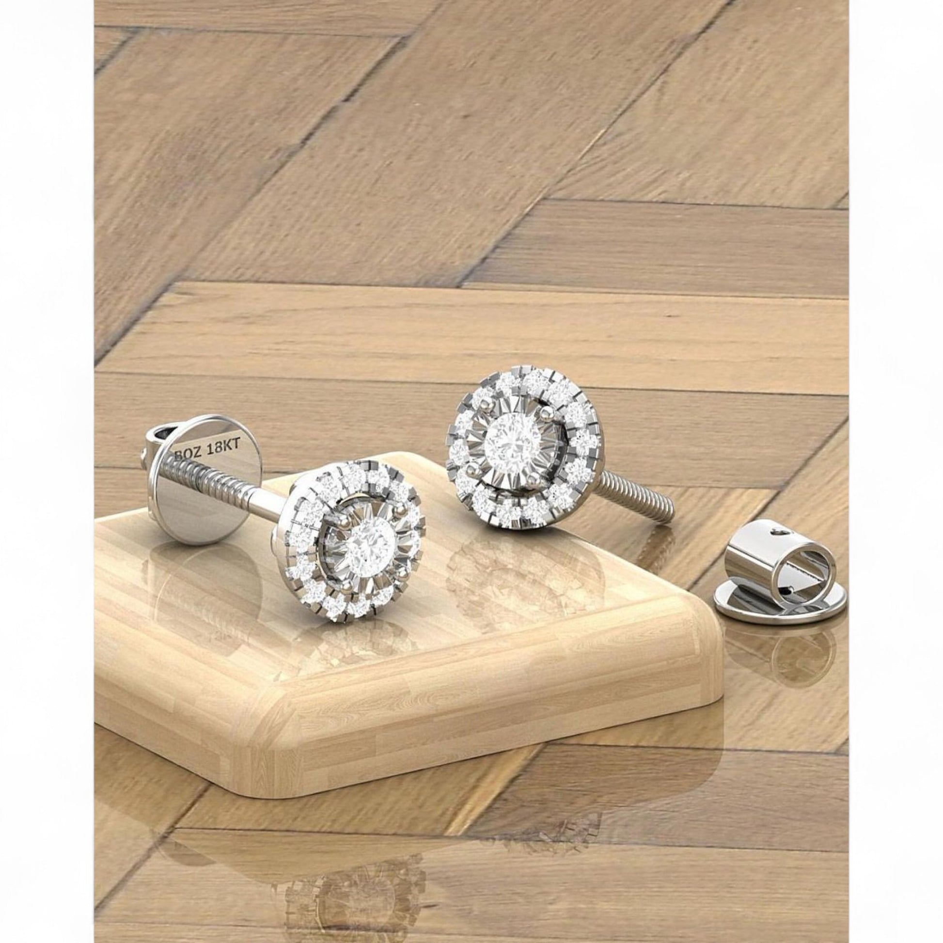Pair of diamond stud earrings on a wooden surface