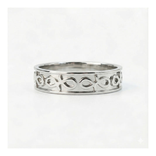 Silver ring with intricate design on a white background