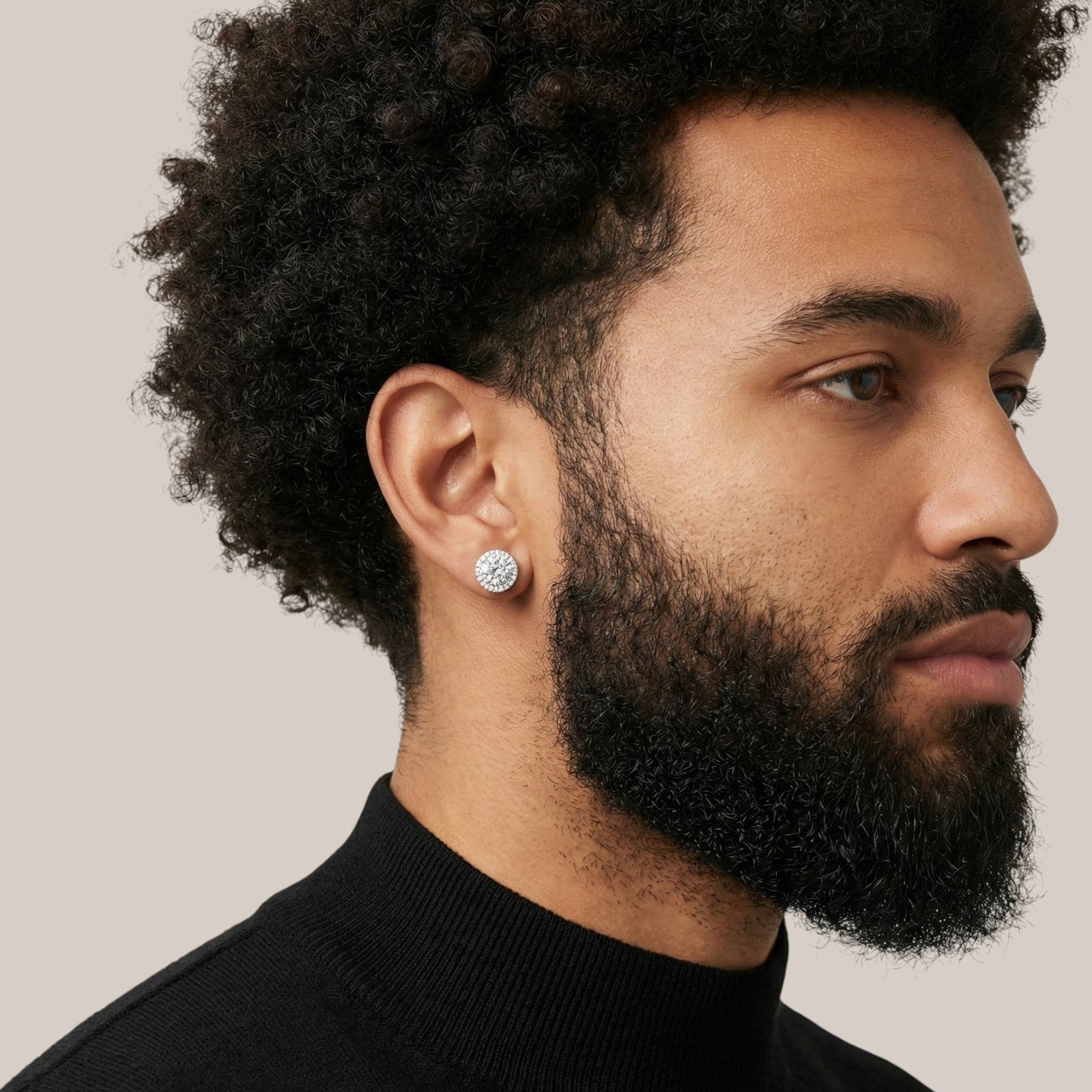 Man wearing a black turtleneck with a neutral background