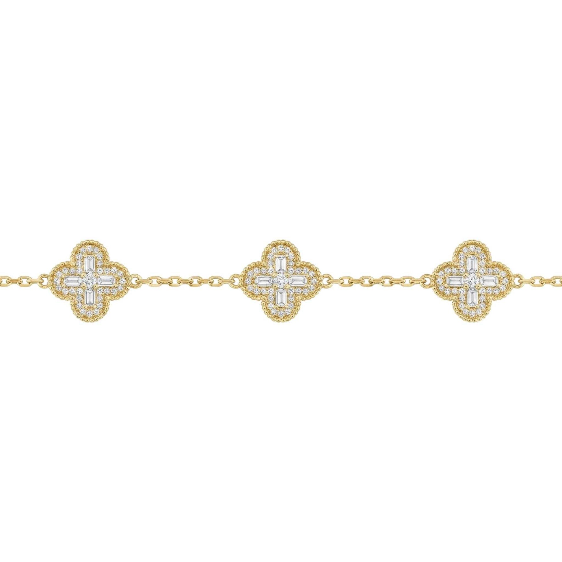 Gold bracelet with diamond-studded clover designs on a white background