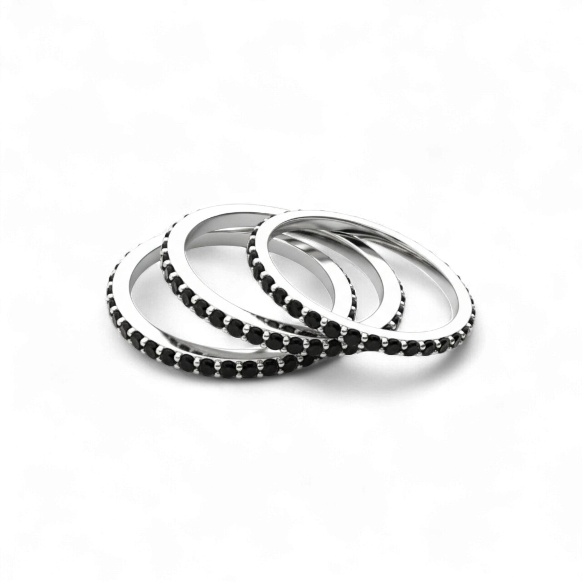 Set of silver and black beaded bracelets on a white background