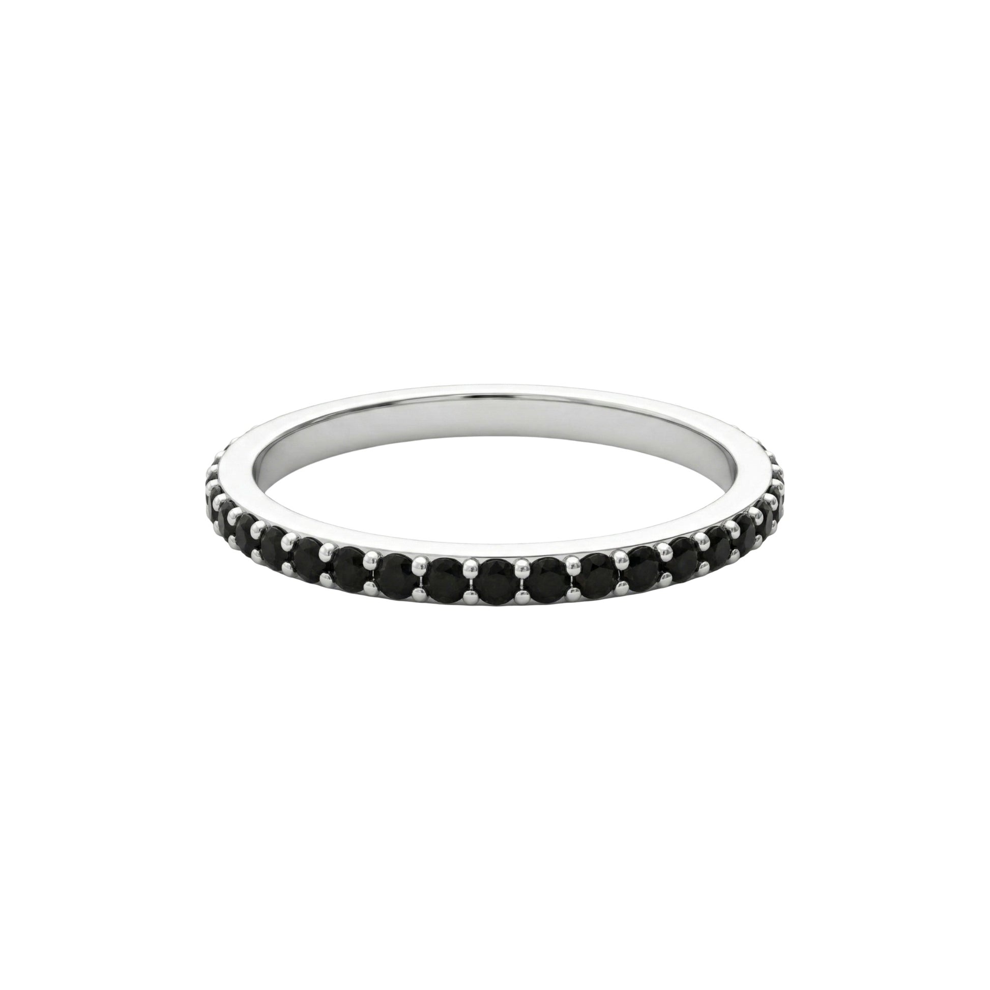 Silver ring with black gemstones on a white background