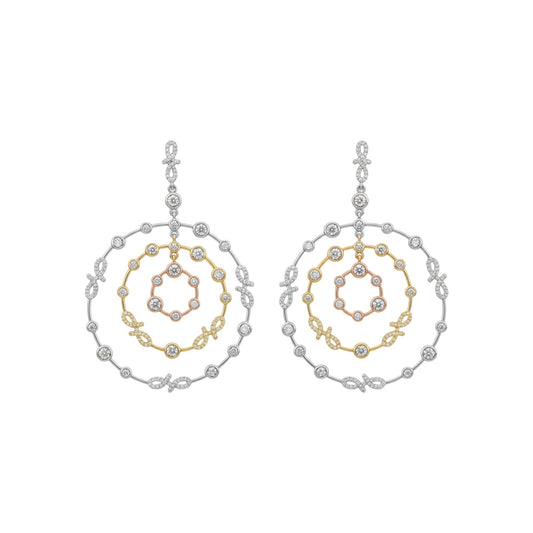 Pair of hoop earrings with gold and silver spiral design on a white background