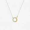 Gold necklace with a unique pendant on a light gray background
