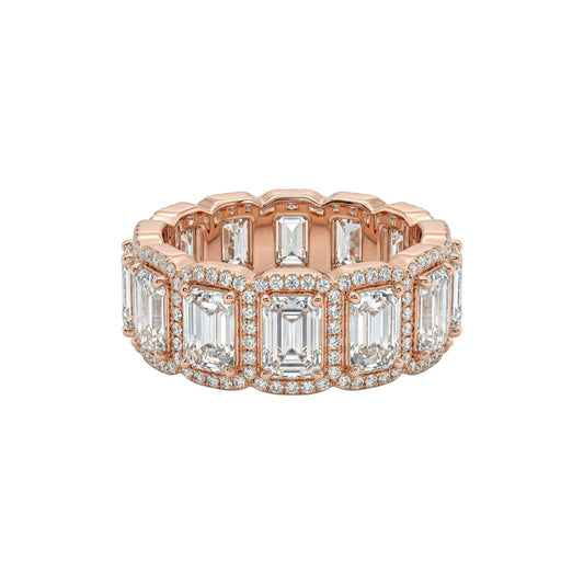 Rose gold ring with emerald-cut diamonds on a white background
