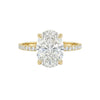 Gold ring with a large diamond and smaller diamonds on the band against a white background