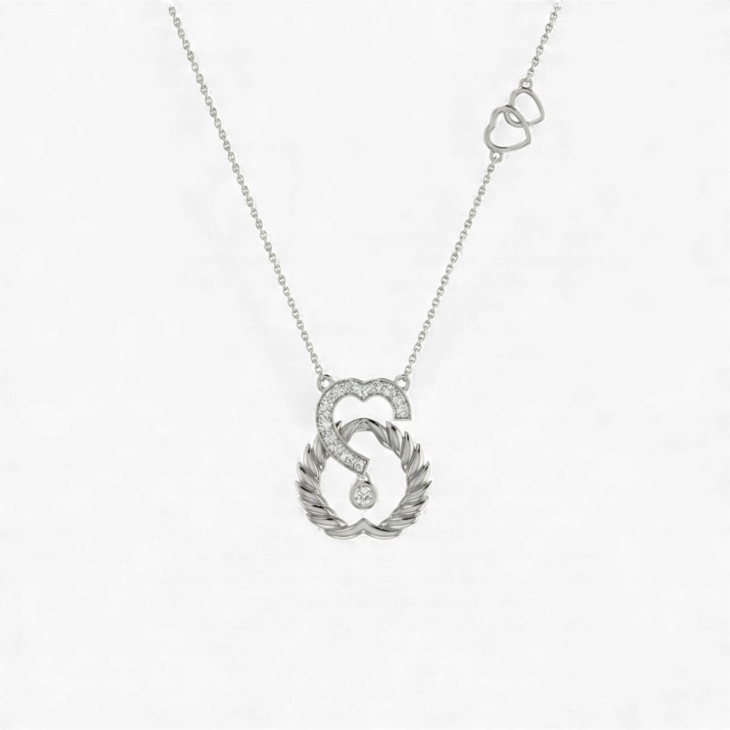 Silver necklace with a heart and leaf design pendant on a white background