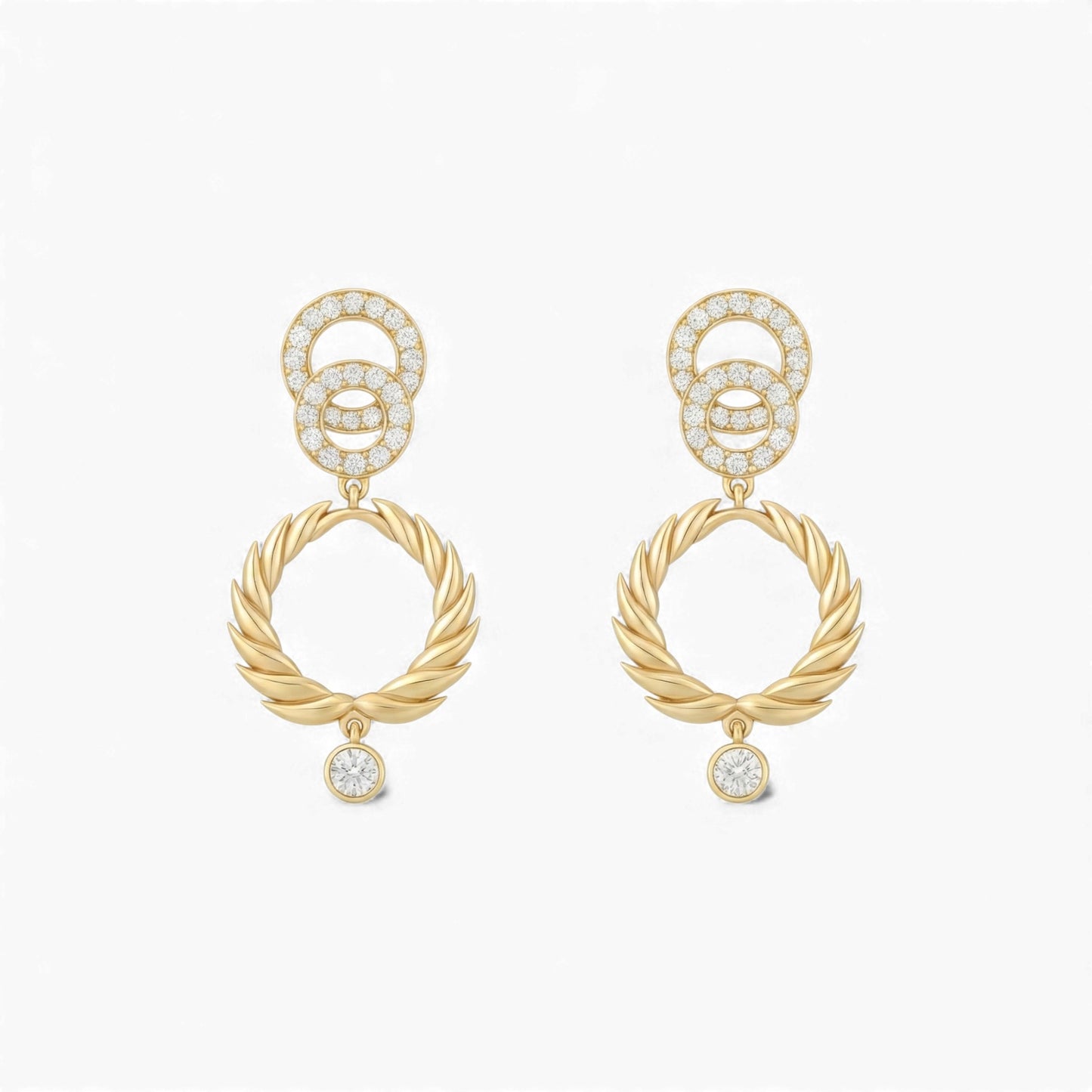 Gold earrings with interlocking rings and small diamonds on a white background