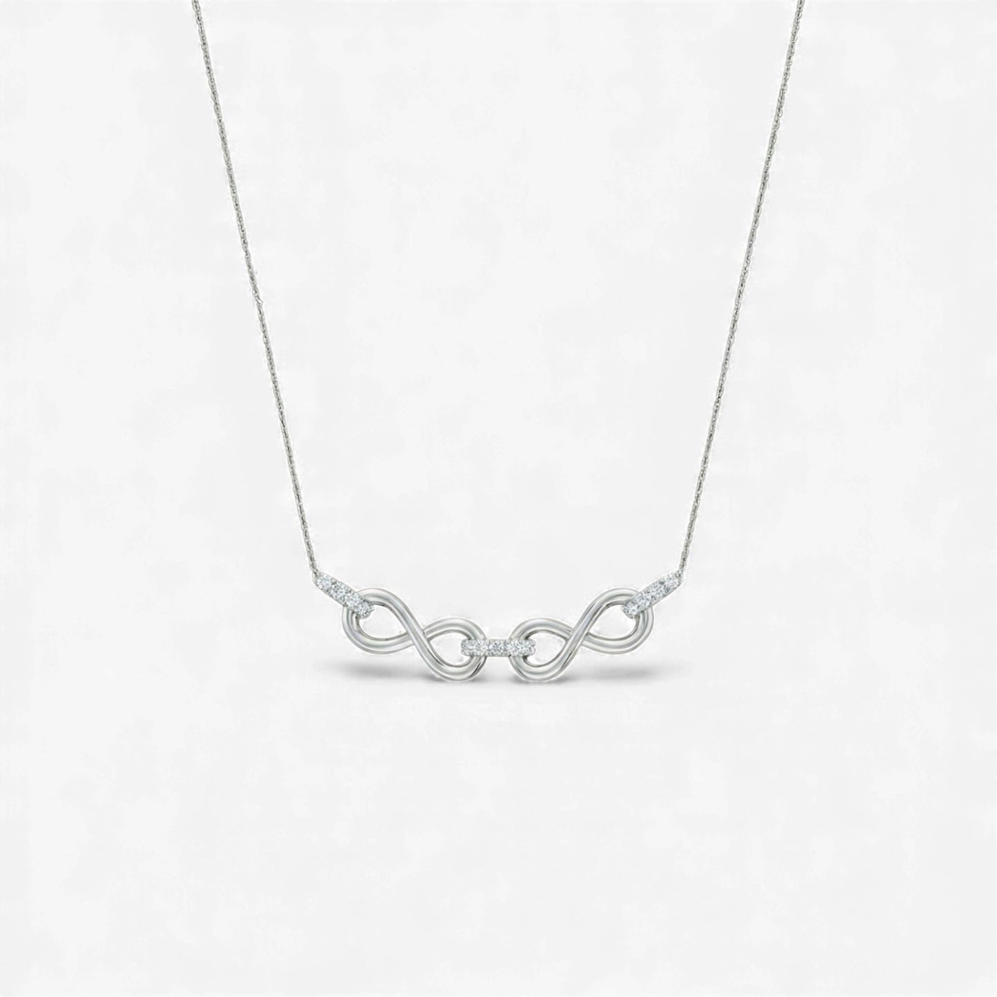 Silver necklace with a unique design on a white background