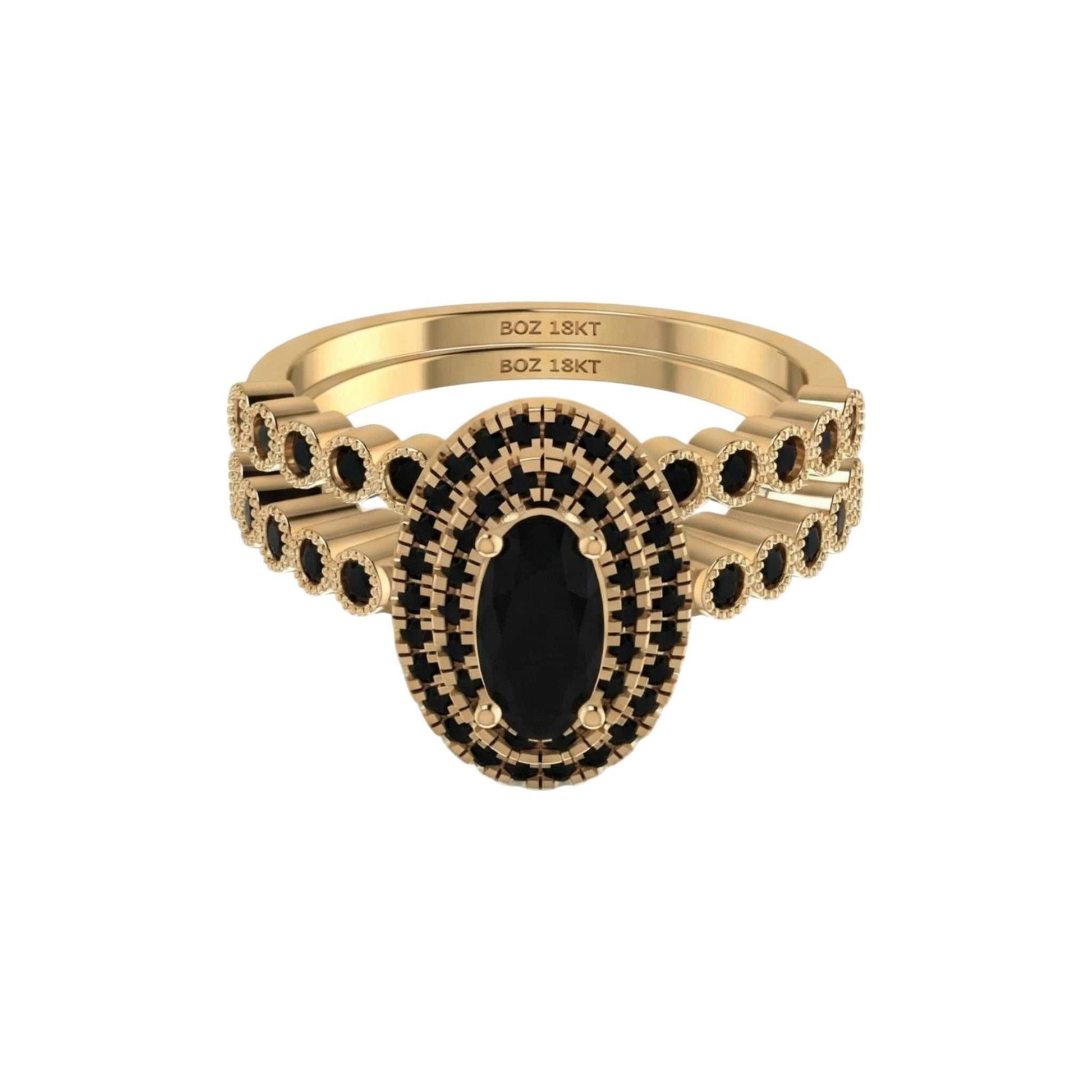 Gold ring with black gemstone on a white background