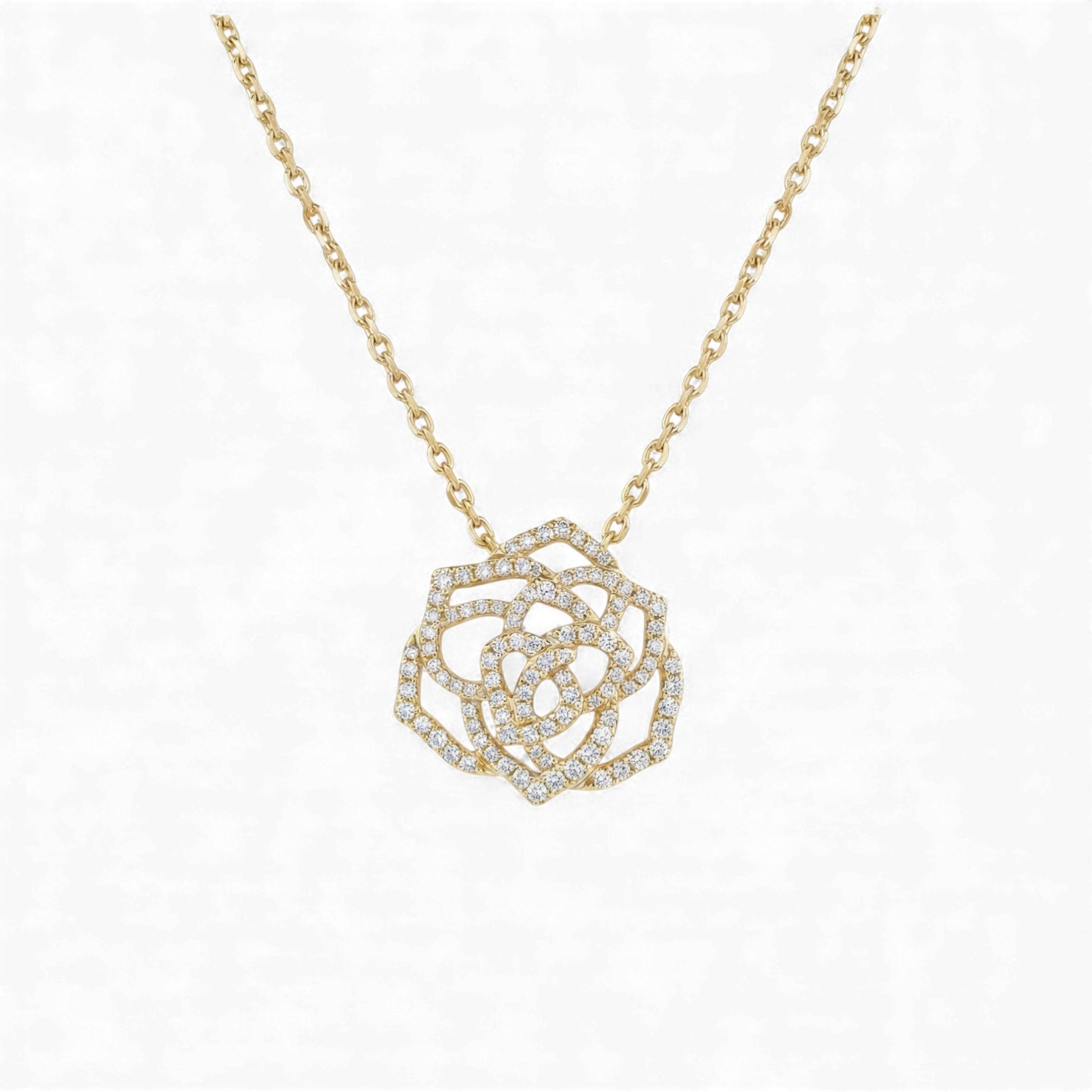 Gold necklace with a diamond-encrusted rose pendant on a white background