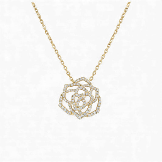 Gold necklace with a diamond-encrusted rose pendant on a white background