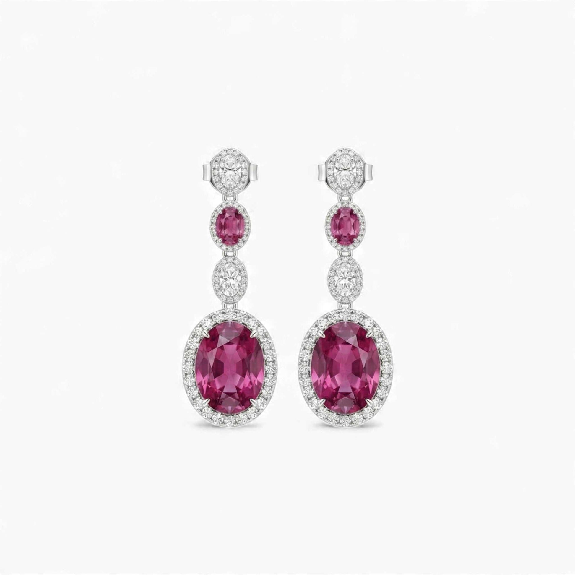 Pair of pink gemstone earrings with diamond accents on a white background