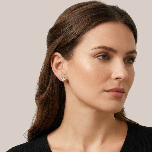 Woman wearing a floral earring with a neutral background