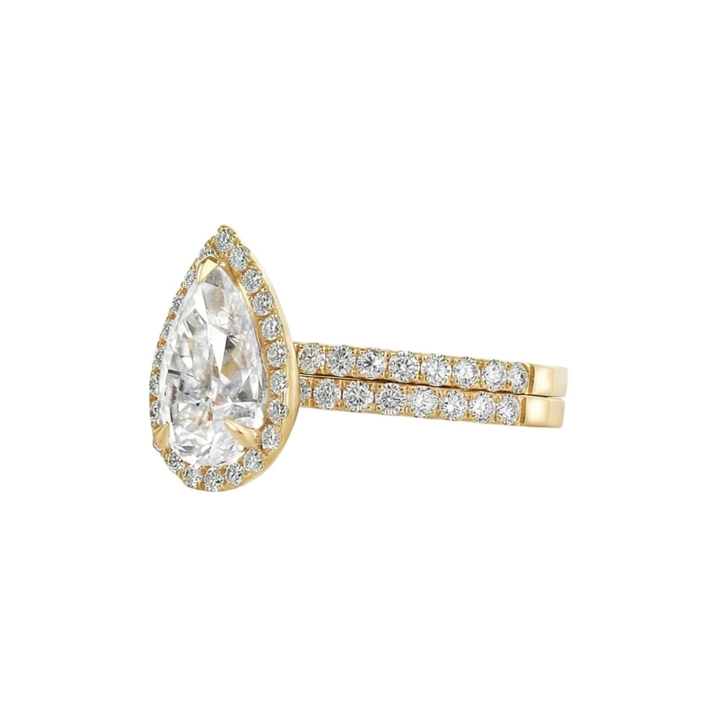 Gold ring with a large pear-shaped diamond and smaller diamonds on the band against a white background
