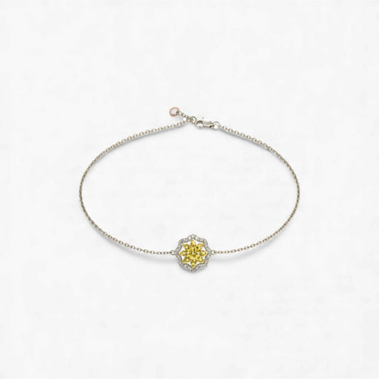 Silver bracelet with a yellow gemstone on a white background