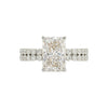 Diamond ring with a rectangular center stone on a white background