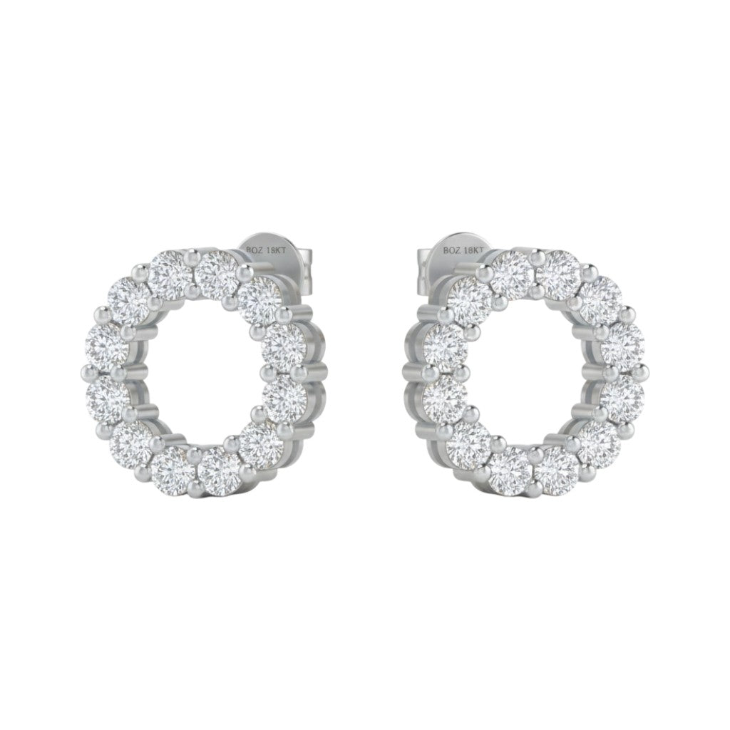Pair of silver hoop earrings with clear gemstones on a white background