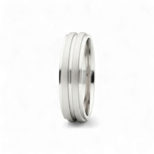 Silver ring with a textured band on a white background