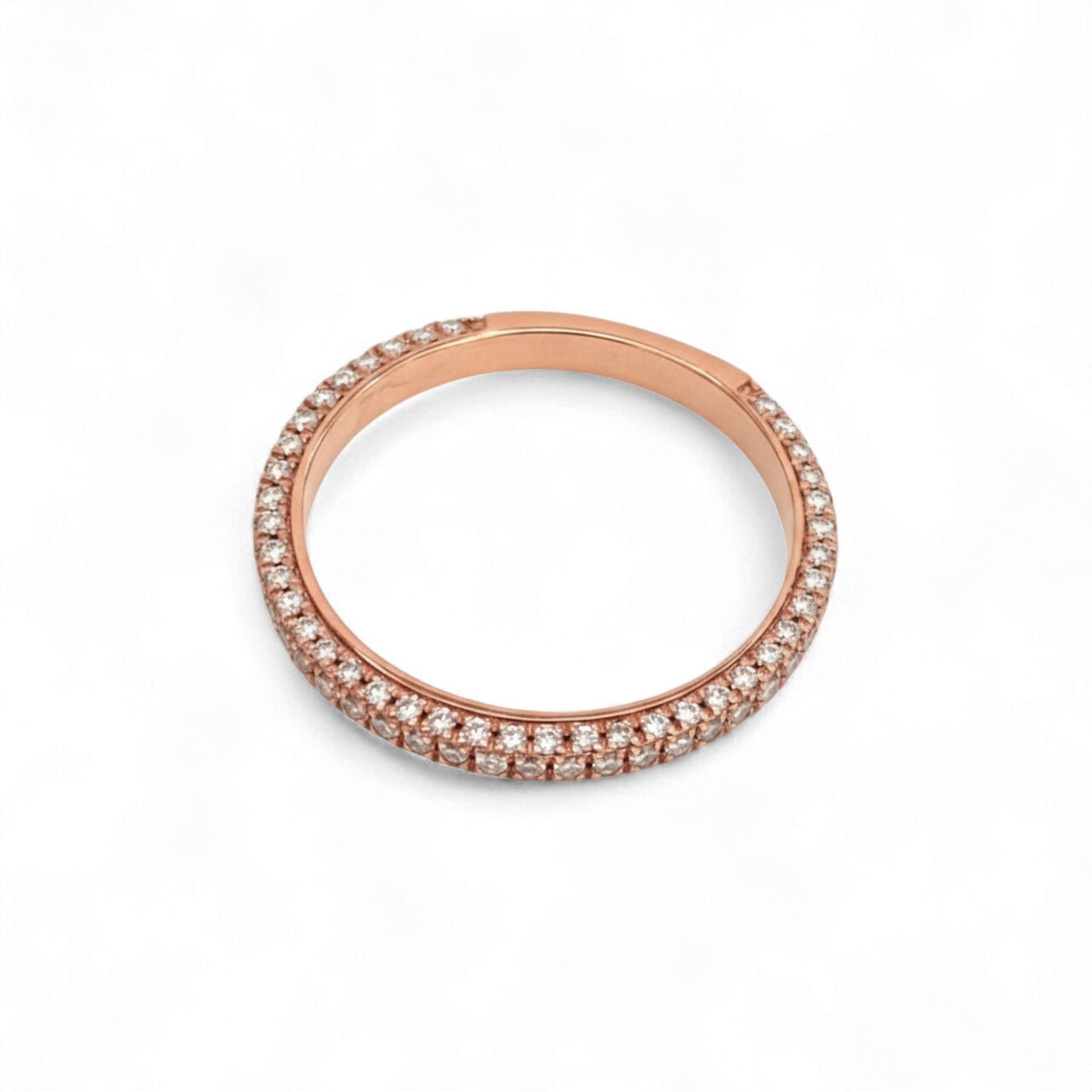 Rose gold ring with small diamonds on a white background