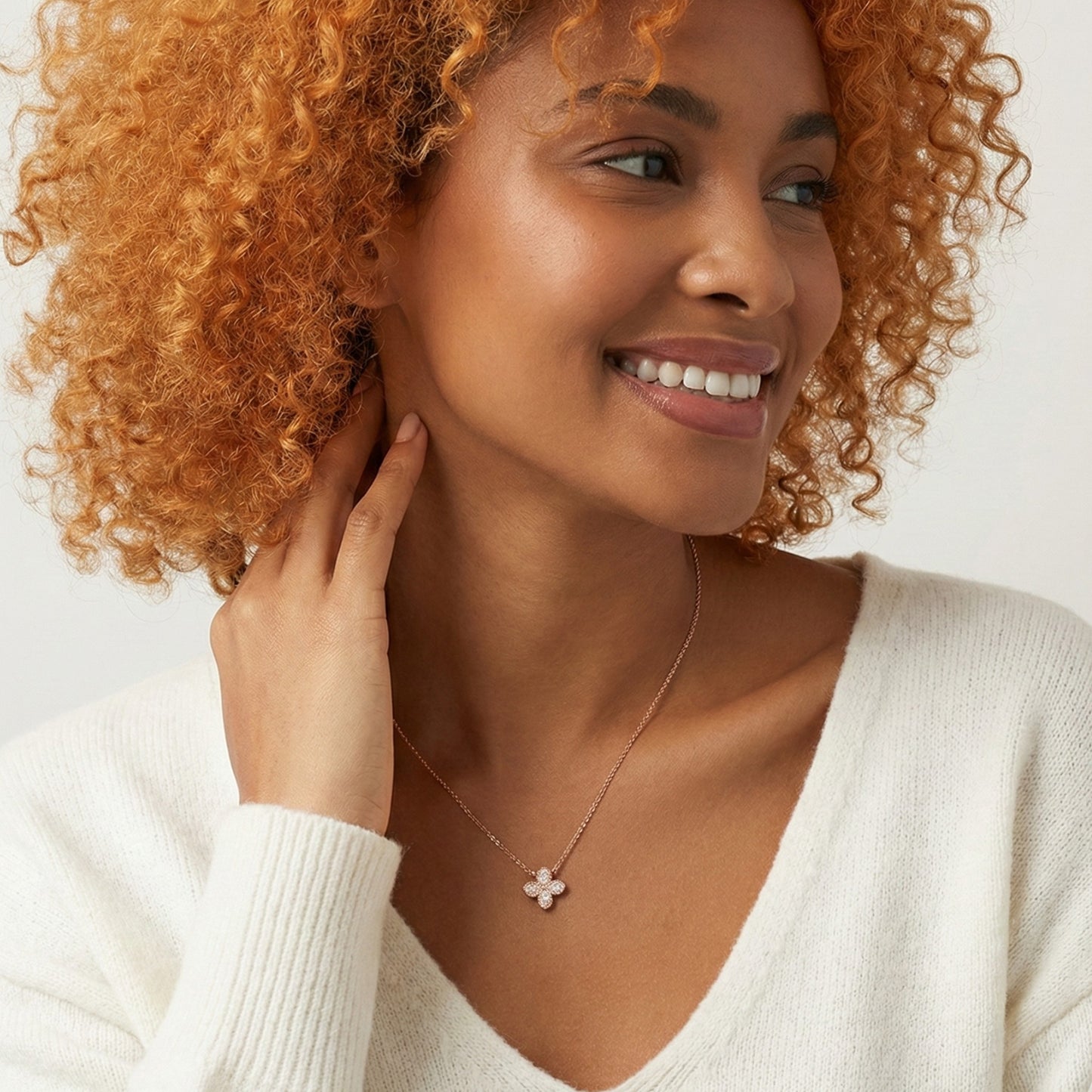 Woman wearing a necklace with a white background