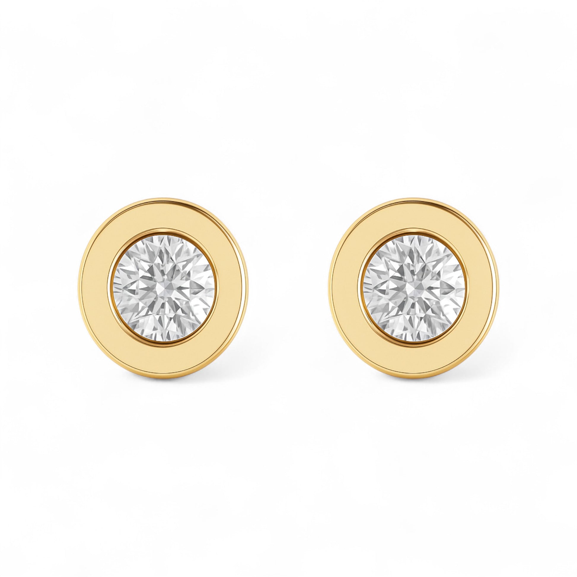 Gold earrings with clear gemstones on a white background
