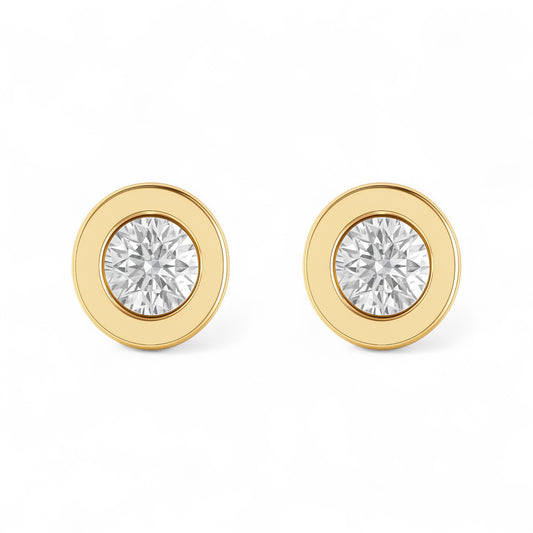 Gold earrings with clear gemstones on a white background