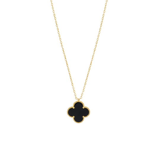Gold necklace with a black clover pendant on a white background